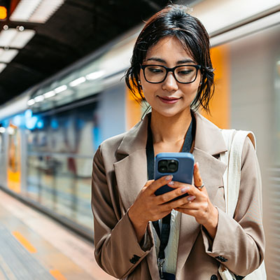 Professional person browsing on their mobile phone while commuting.
