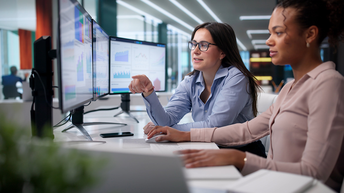 Two marketing professionals looking at a computer screen and collaborating